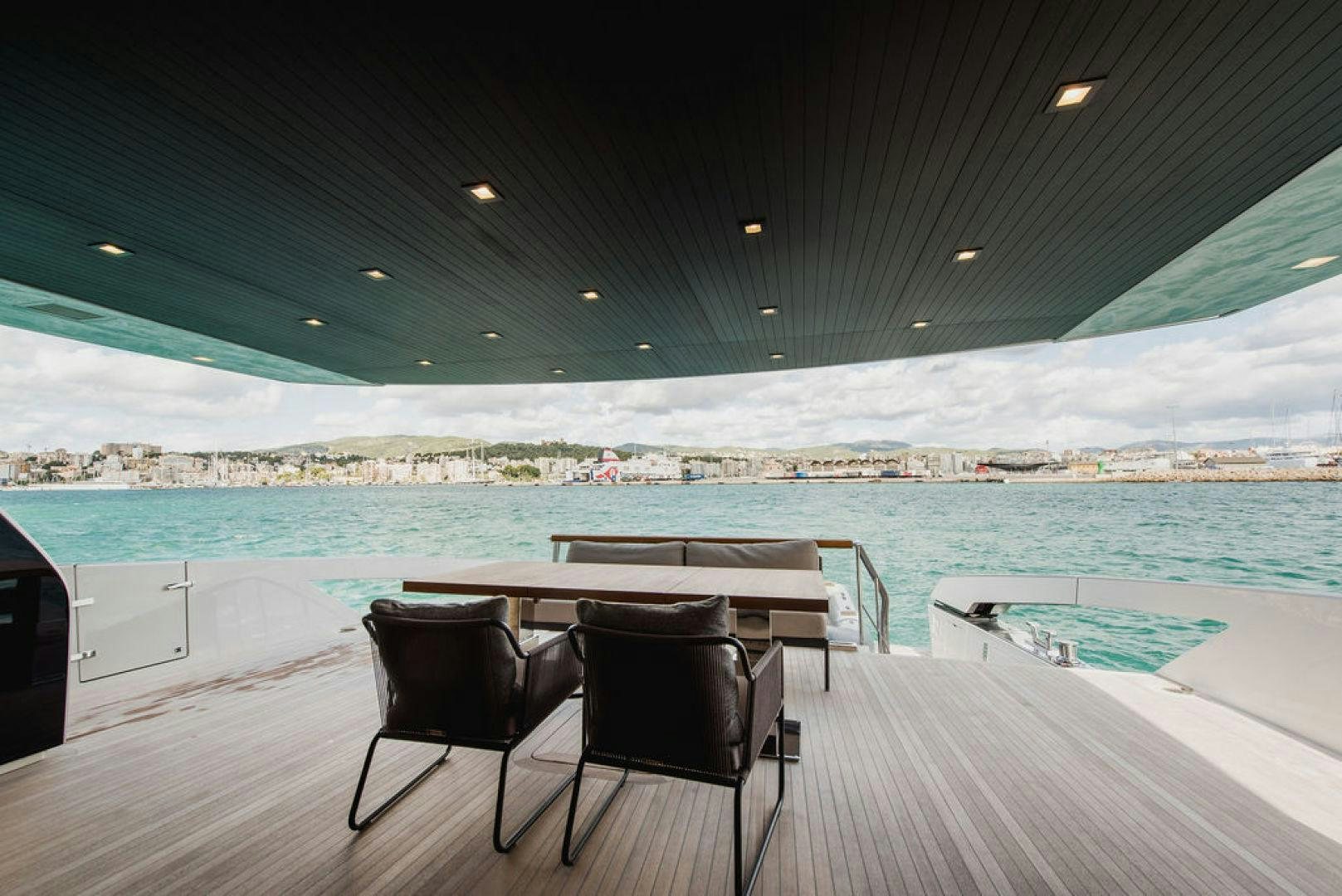 a table and chairs on a deck overlooking a body of water aboard ZAZZAZU II Yacht for Sale