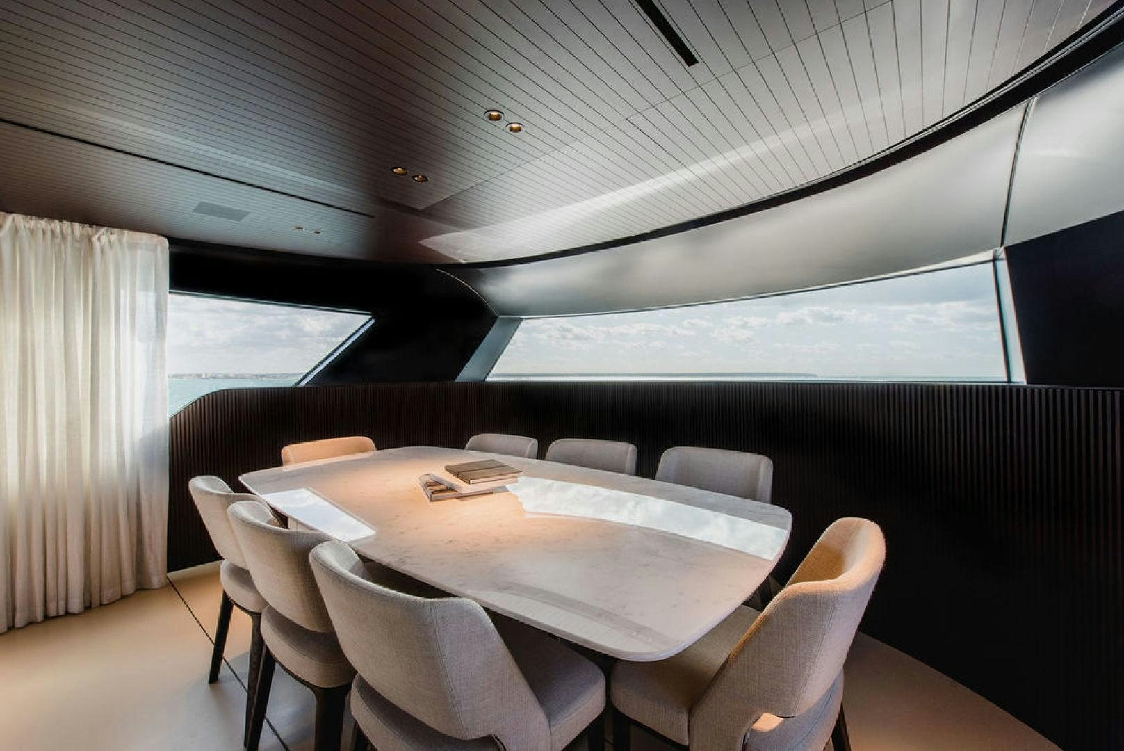 a room with a table and chairs aboard ZAZZAZU II Yacht for Sale