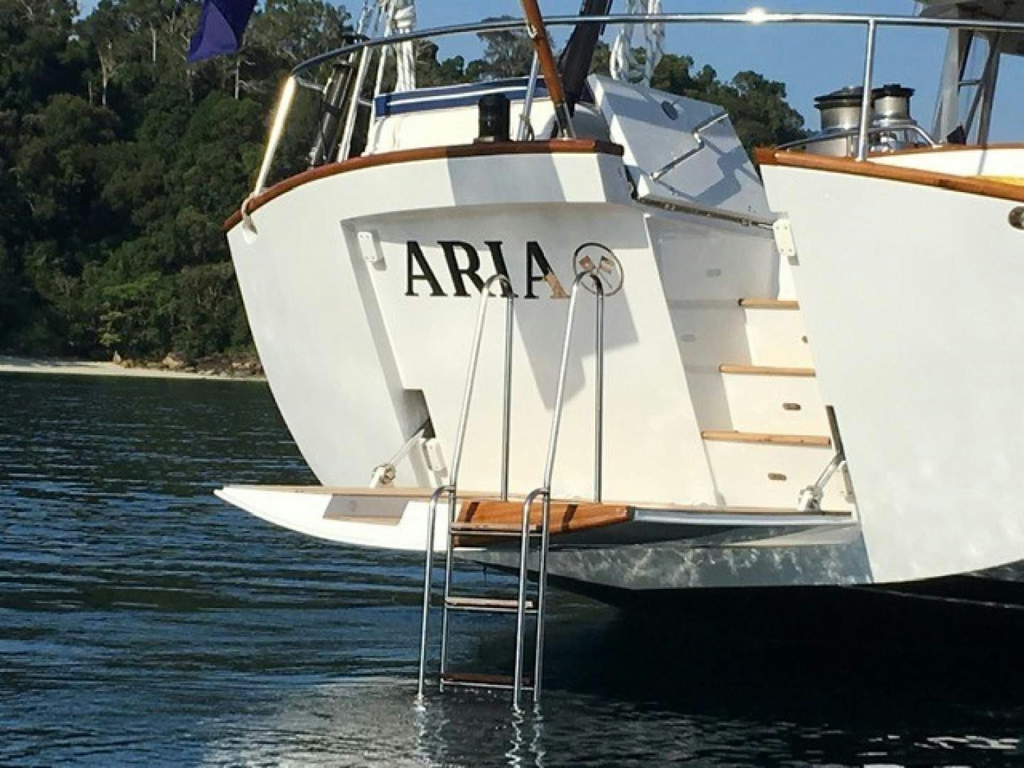 a white boat in the water aboard ARIA Yacht for Sale