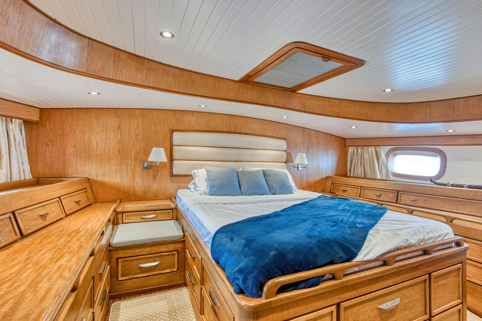 a room with a bed and a window aboard ARIA Yacht for Sale