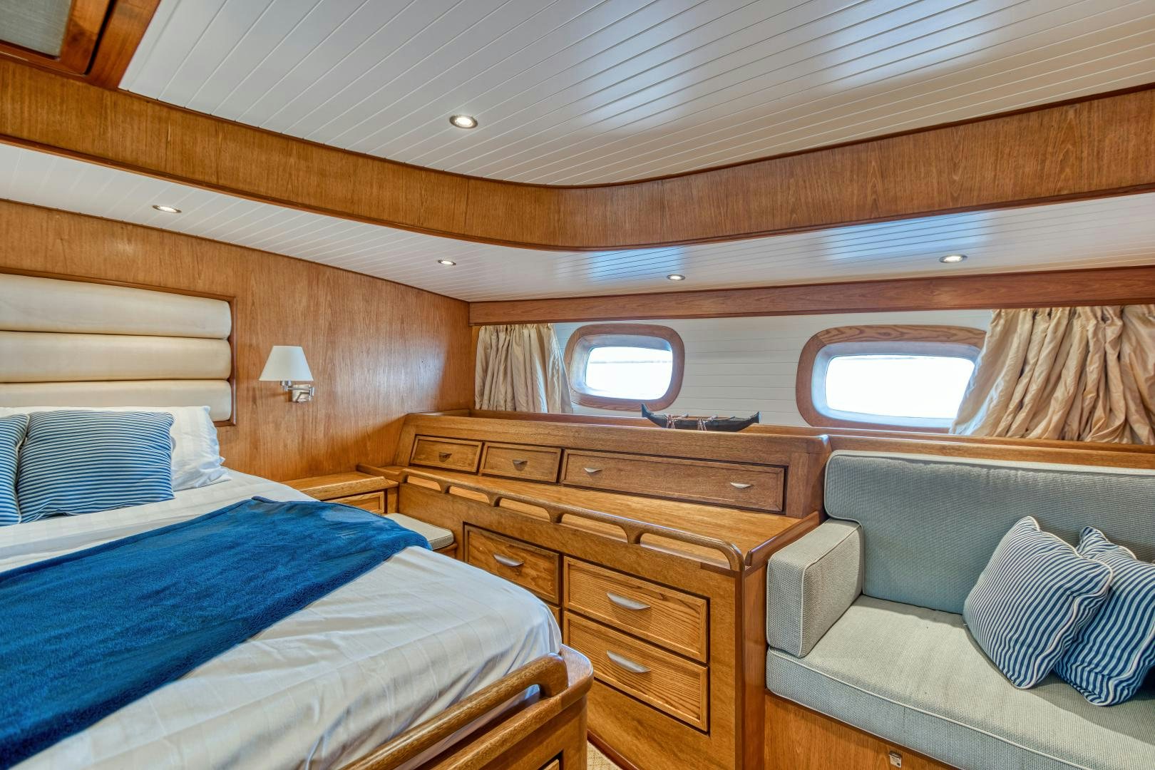 a room with a bed and a couch aboard ARIA Yacht for Sale