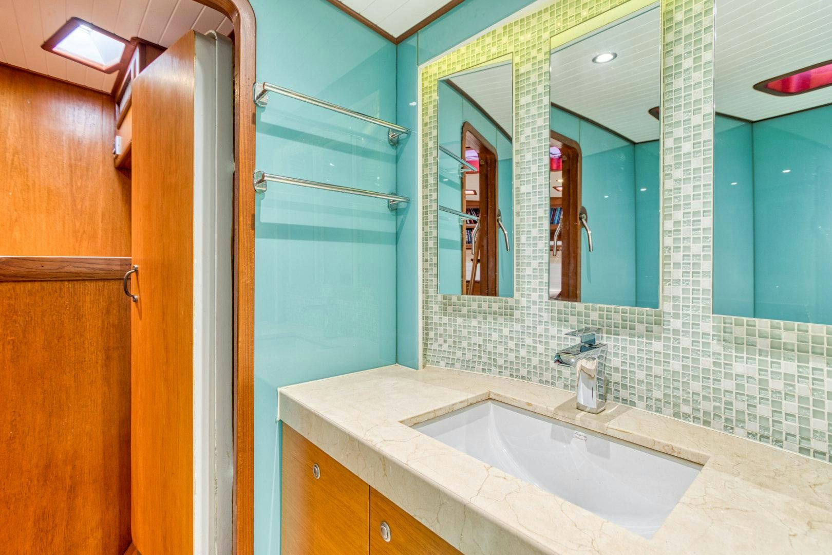a bathroom with a sink and mirror aboard ARIA Yacht for Sale