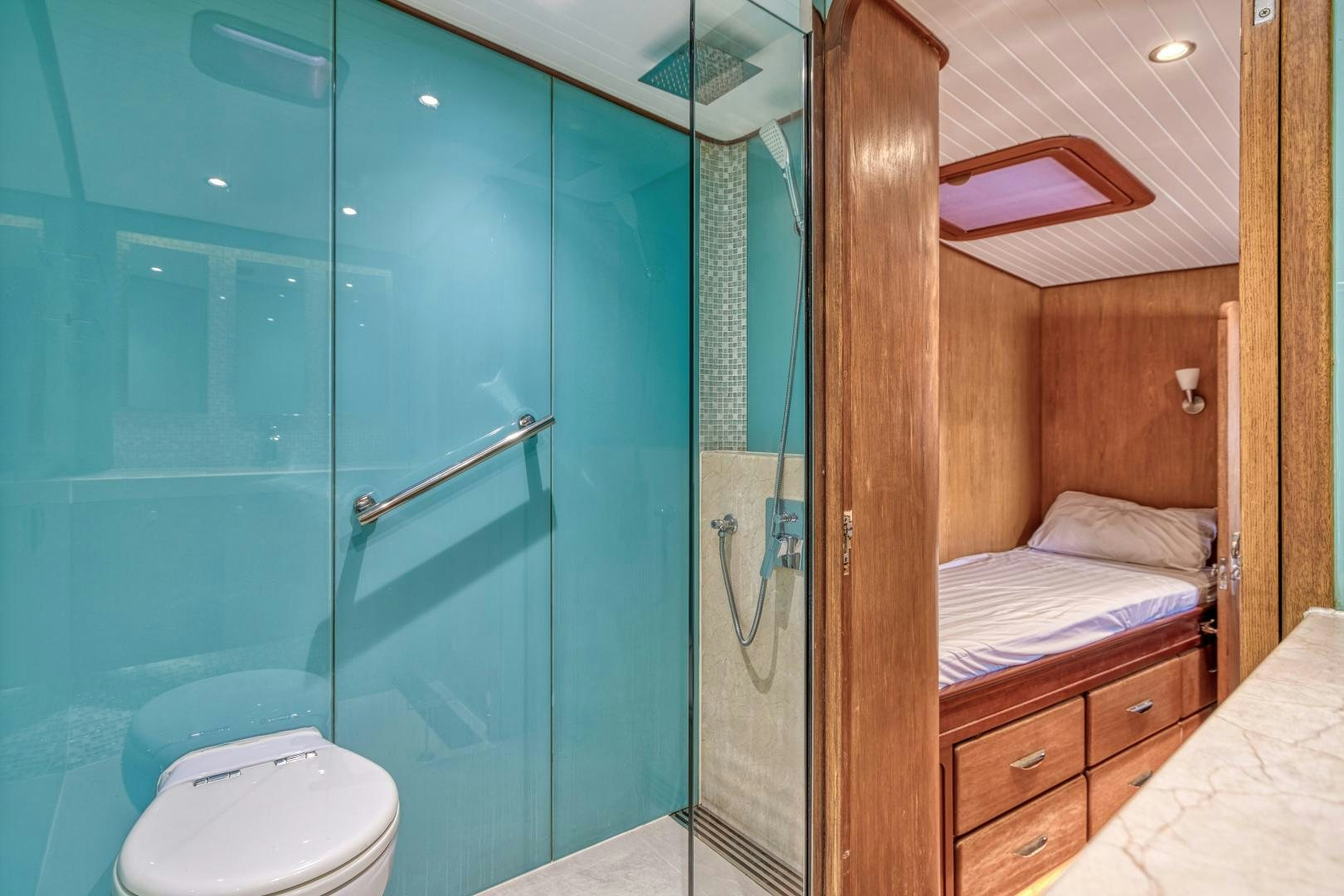 a bathroom with a glass shower aboard ARIA Yacht for Sale