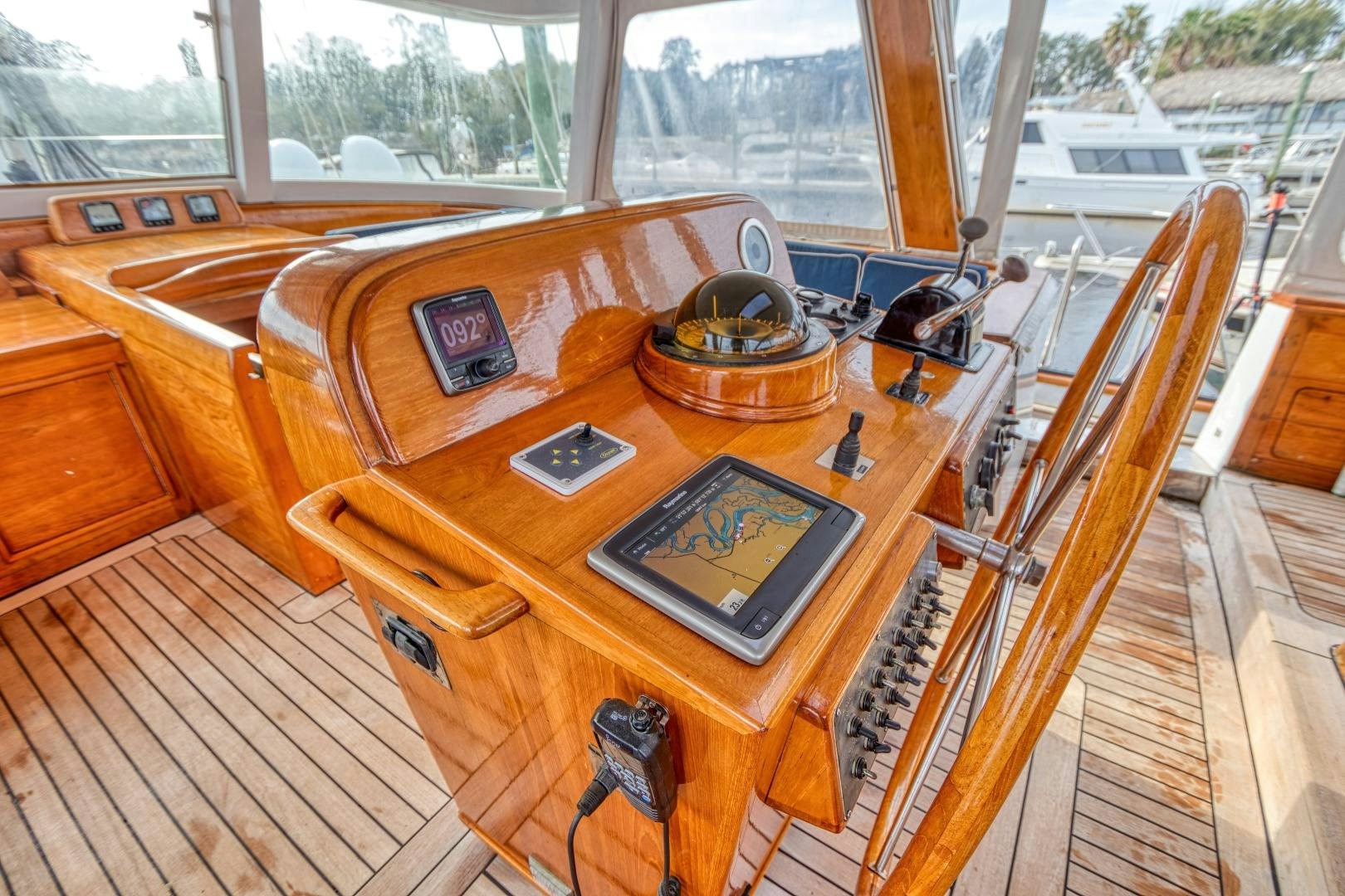 a wooden table with a laptop and a cell phone on it aboard ARIA Yacht for Sale