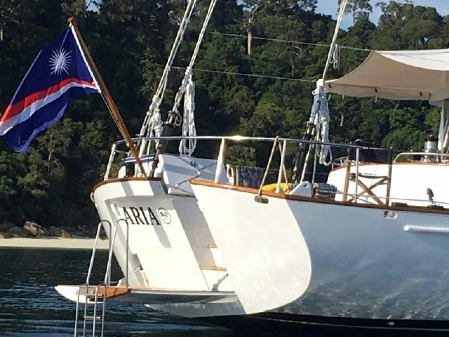 a boat with a flag on it aboard ARIA Yacht for Sale