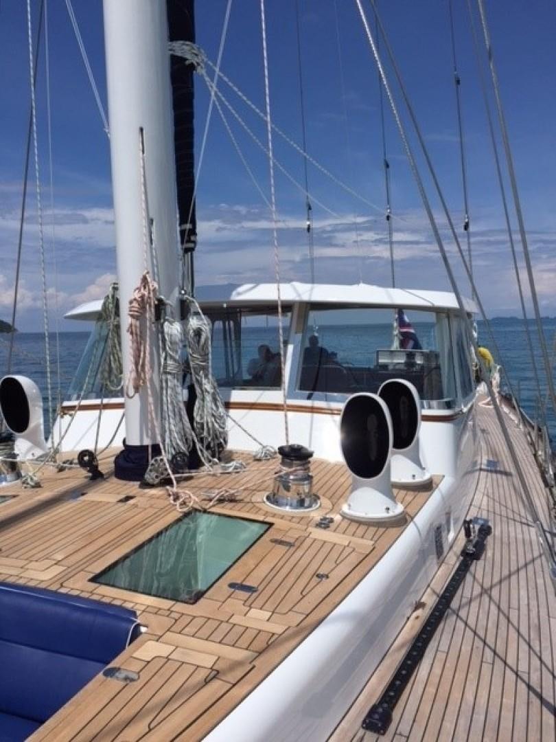 a boat with a deck and a deck and a table with a glass and a table with a aboard ARIA Yacht for Sale