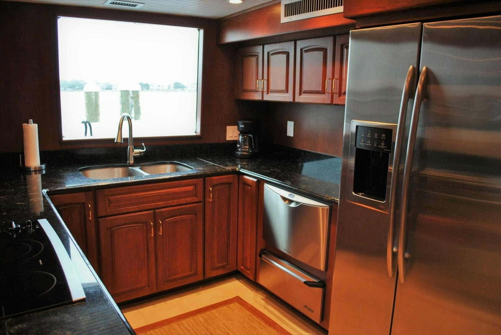 a kitchen with a stainless steel refrigerator aboard JENNY LYNNE Yacht for Sale