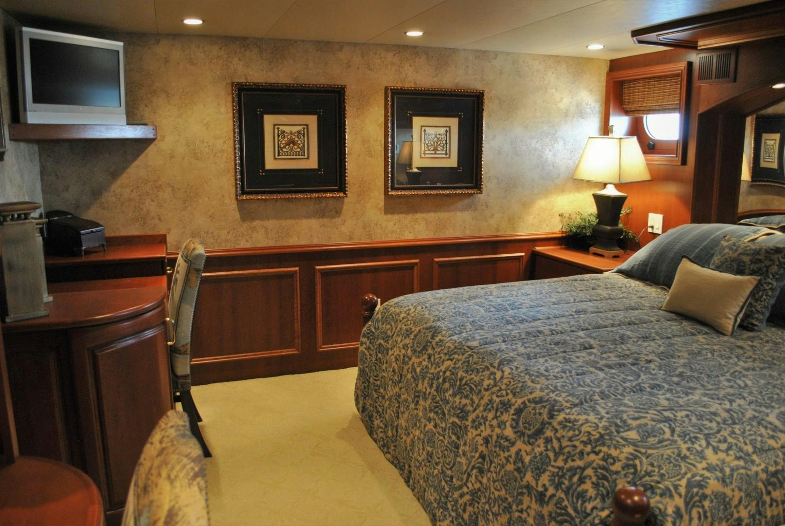 a bedroom with a bed and a television aboard JENNY LYNNE Yacht for Sale