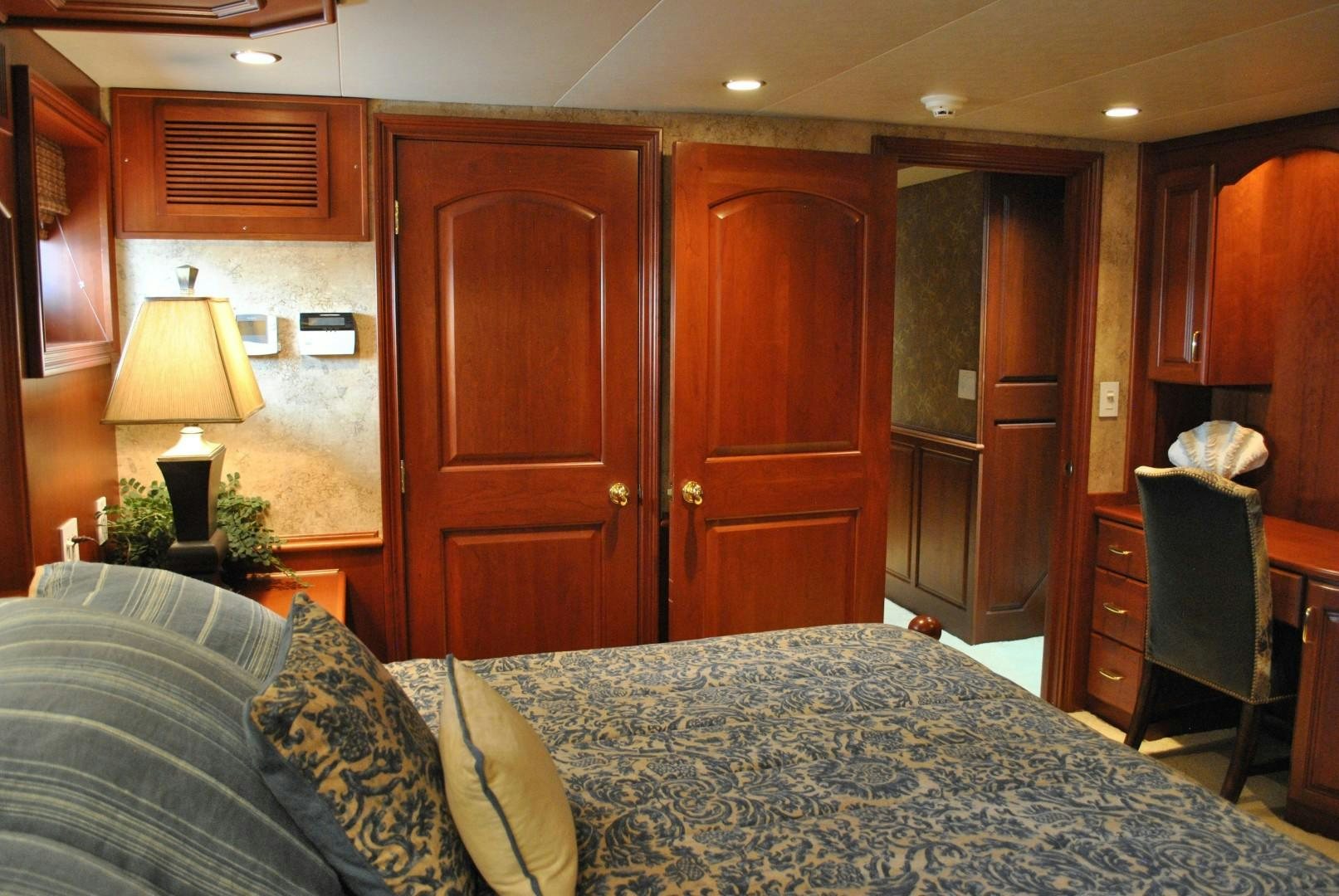 a bedroom with a bed and a desk aboard JENNY LYNNE Yacht for Sale