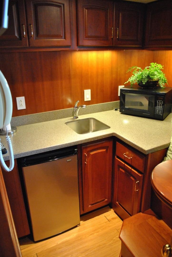 a kitchen with wooden cabinets aboard JENNY LYNNE Yacht for Sale