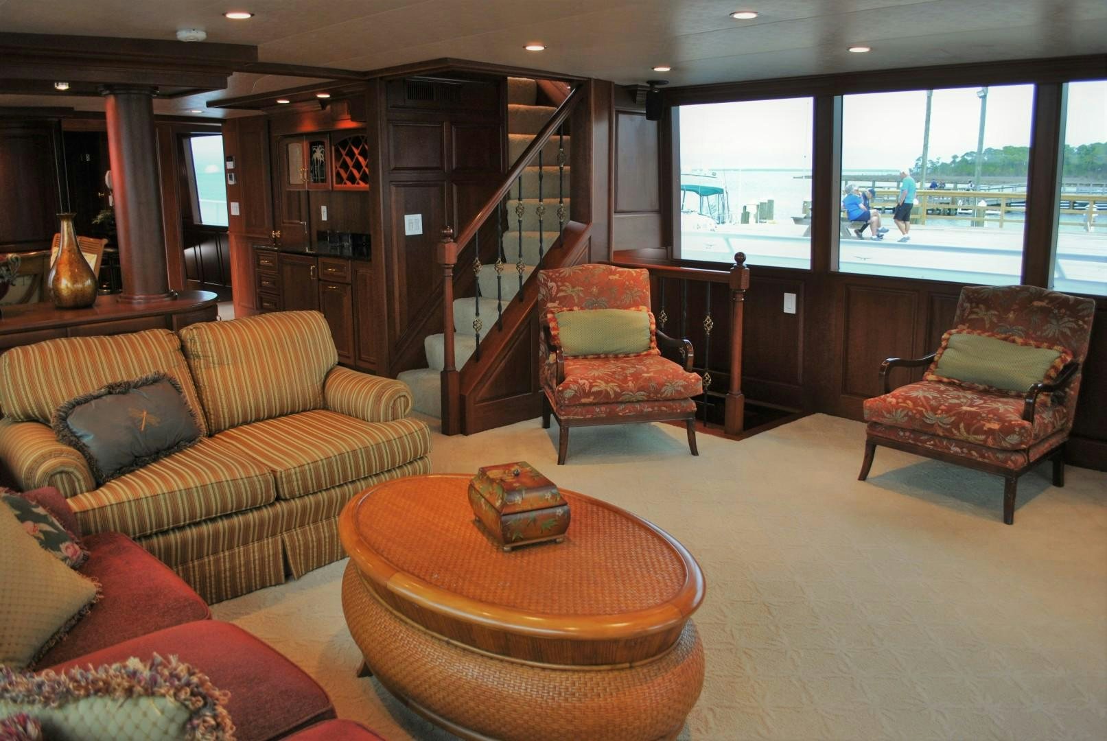 a living room with a staircase and a staircase aboard JENNY LYNNE Yacht for Sale