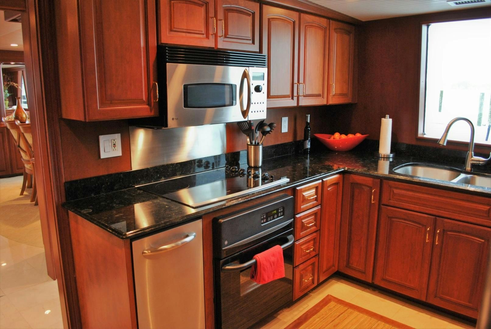 a kitchen with wooden cabinets aboard JENNY LYNNE Yacht for Sale