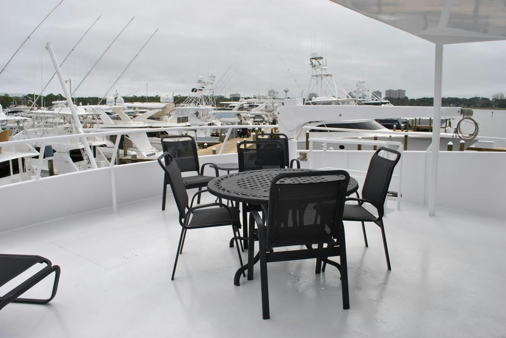 a table with chairs on it aboard JENNY LYNNE Yacht for Sale