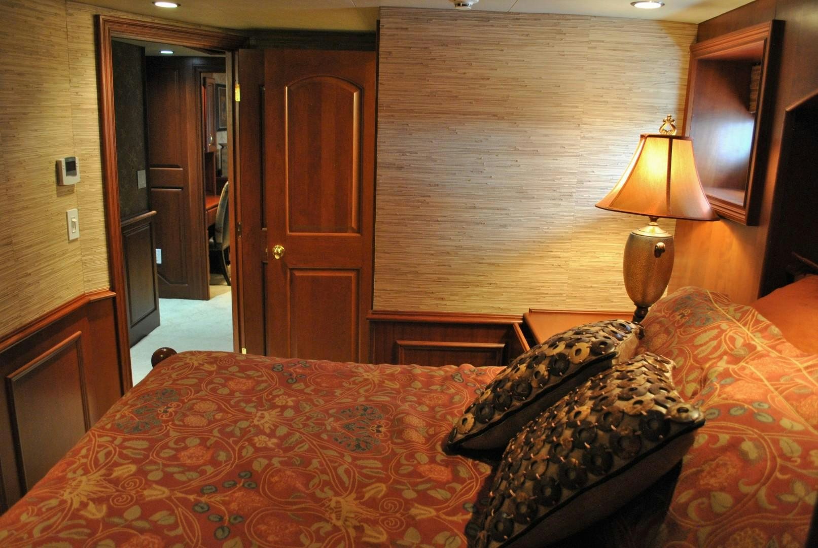 a bedroom with a bed and a lamp aboard JENNY LYNNE Yacht for Sale