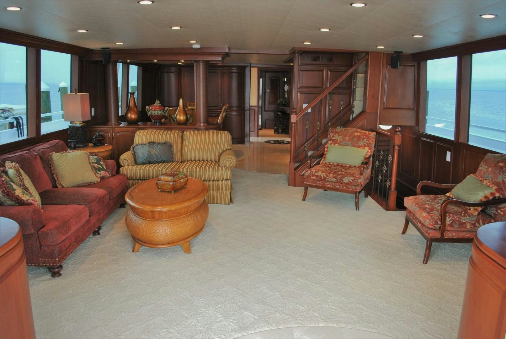 a living room with a staircase aboard JENNY LYNNE Yacht for Sale