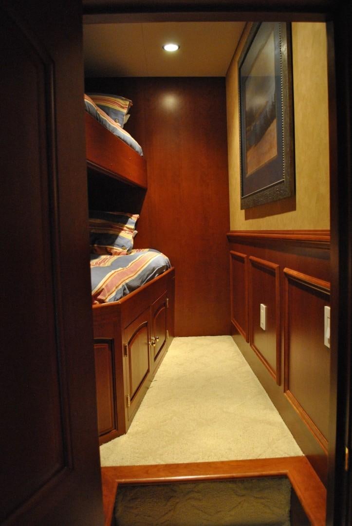 a bedroom with a bed and a desk aboard JENNY LYNNE Yacht for Sale