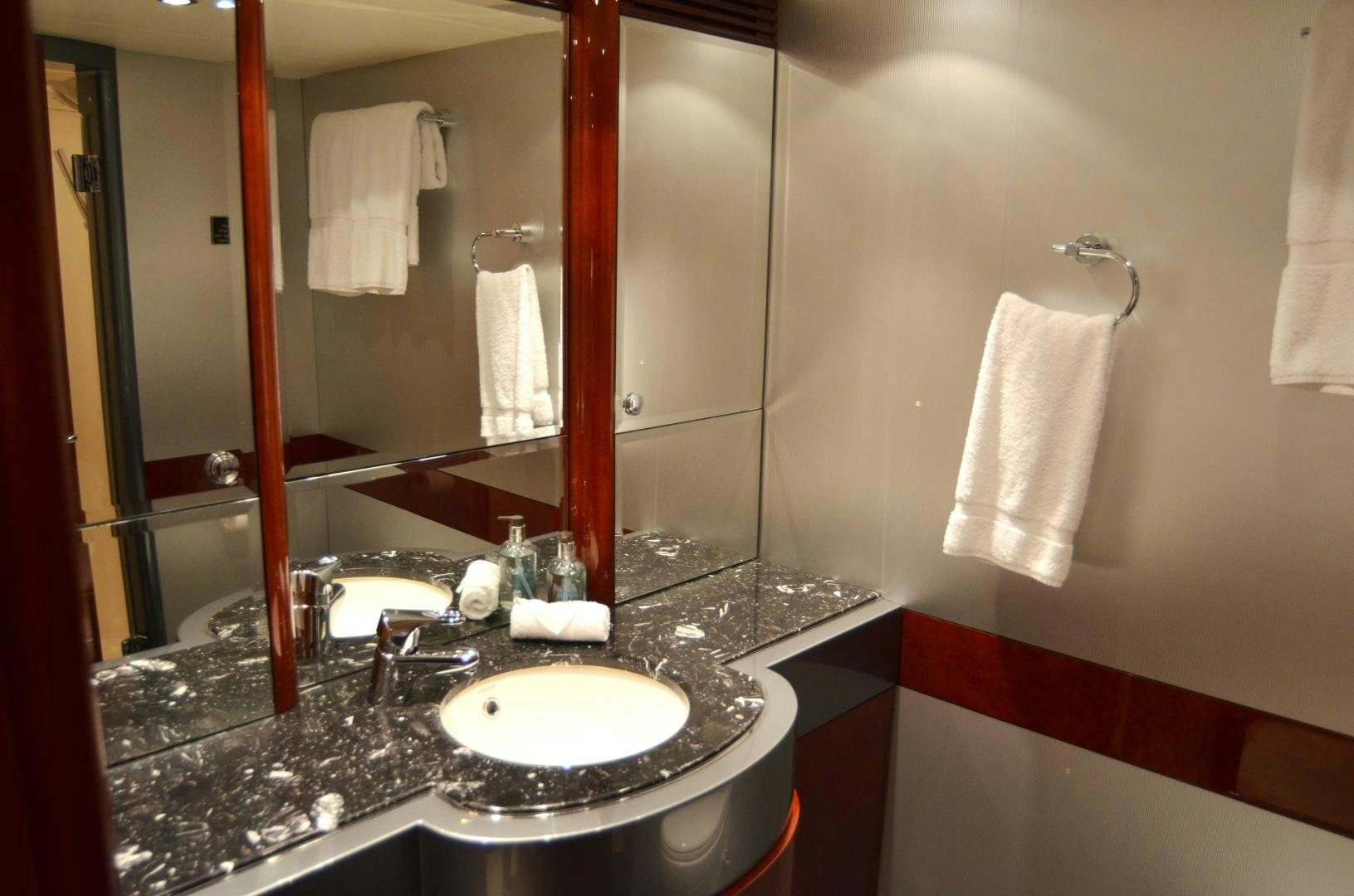 a bathroom with a sink and a mirror aboard ANDIAMO Yacht for Sale