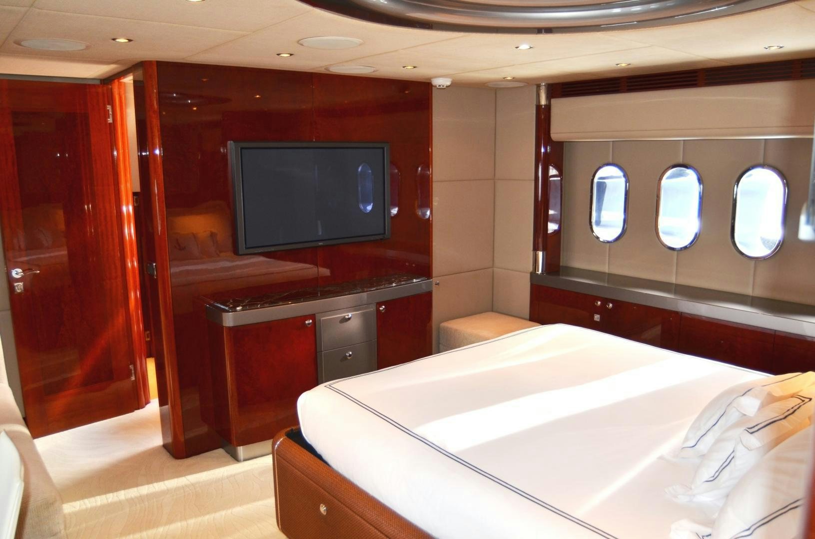 a room with a bed and a tv aboard ANDIAMO Yacht for Sale