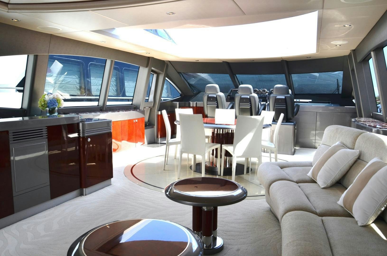 a room with a table chairs and a tv aboard ANDIAMO Yacht for Sale