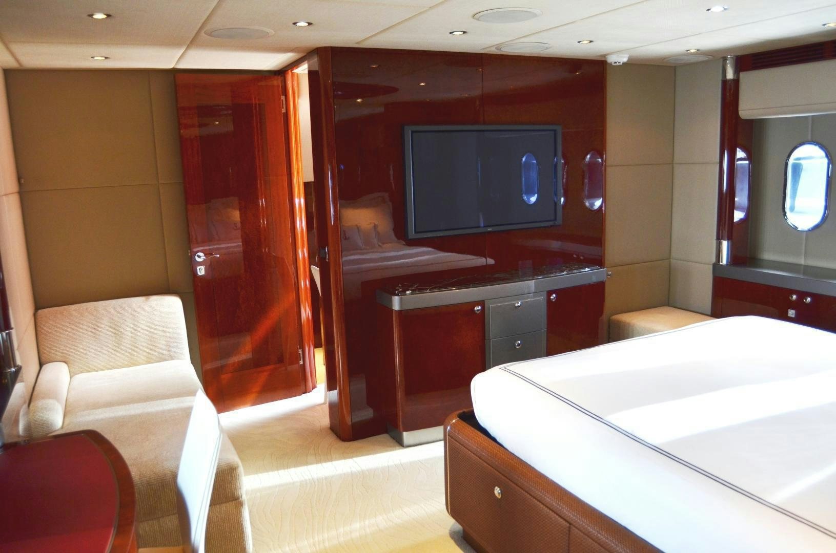 a room with a tv and a bed aboard ANDIAMO Yacht for Sale