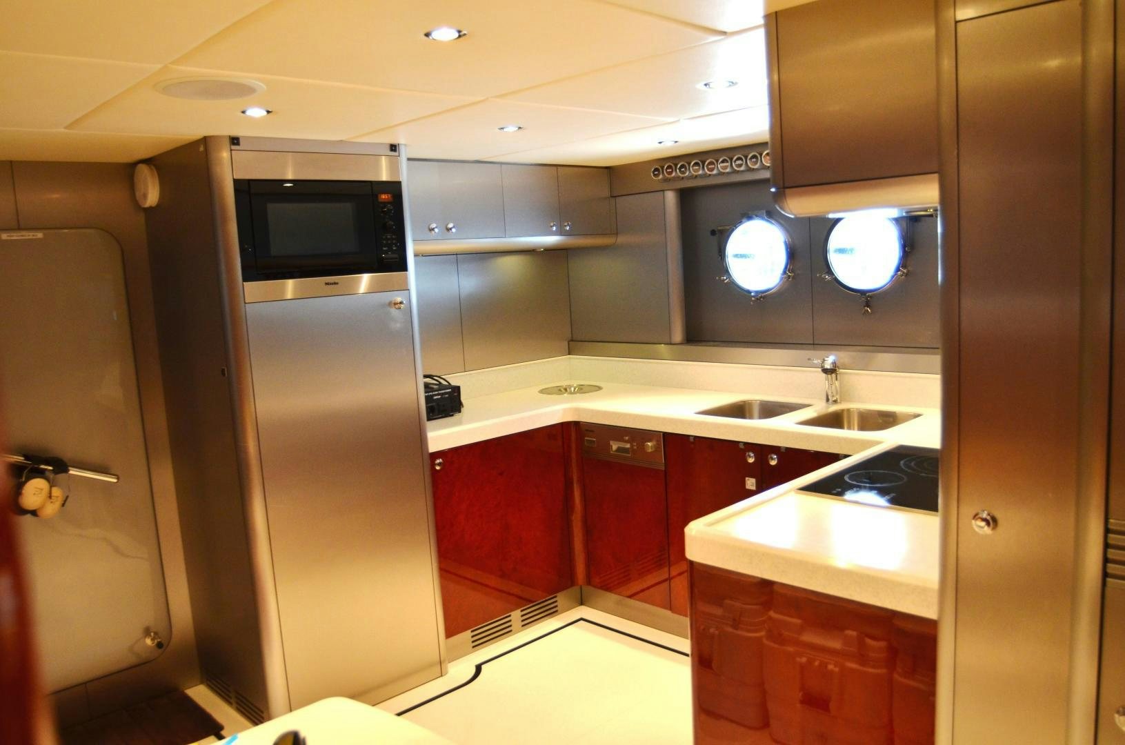 a kitchen with red cabinets aboard ANDIAMO Yacht for Sale