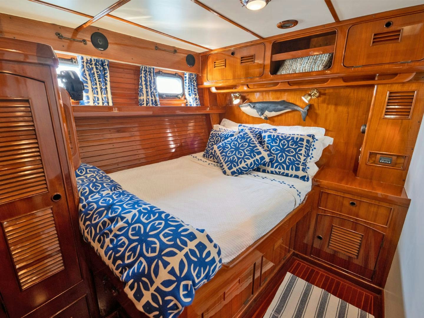 a cabin with a bed and a chair aboard HERMIE LOUISE Yacht for Sale