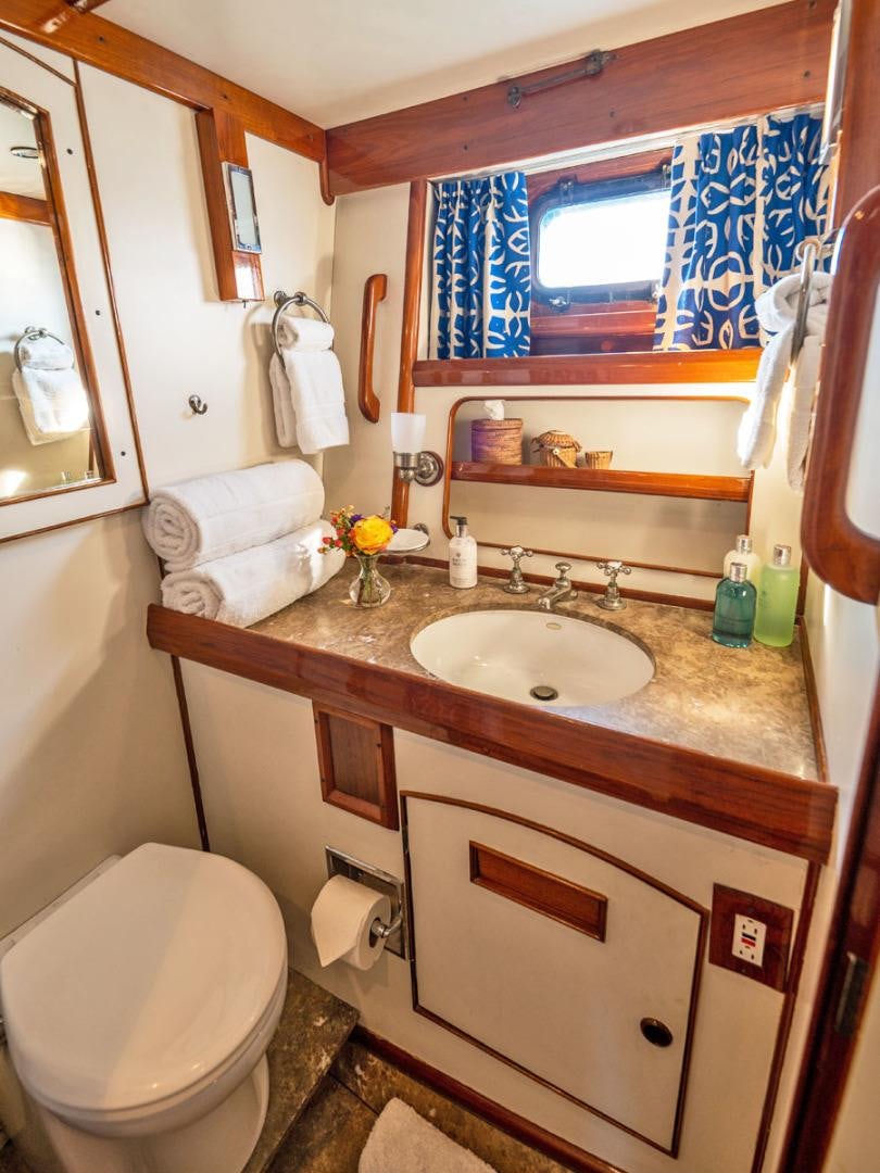 a bathroom with a sink and toilet aboard HERMIE LOUISE Yacht for Sale