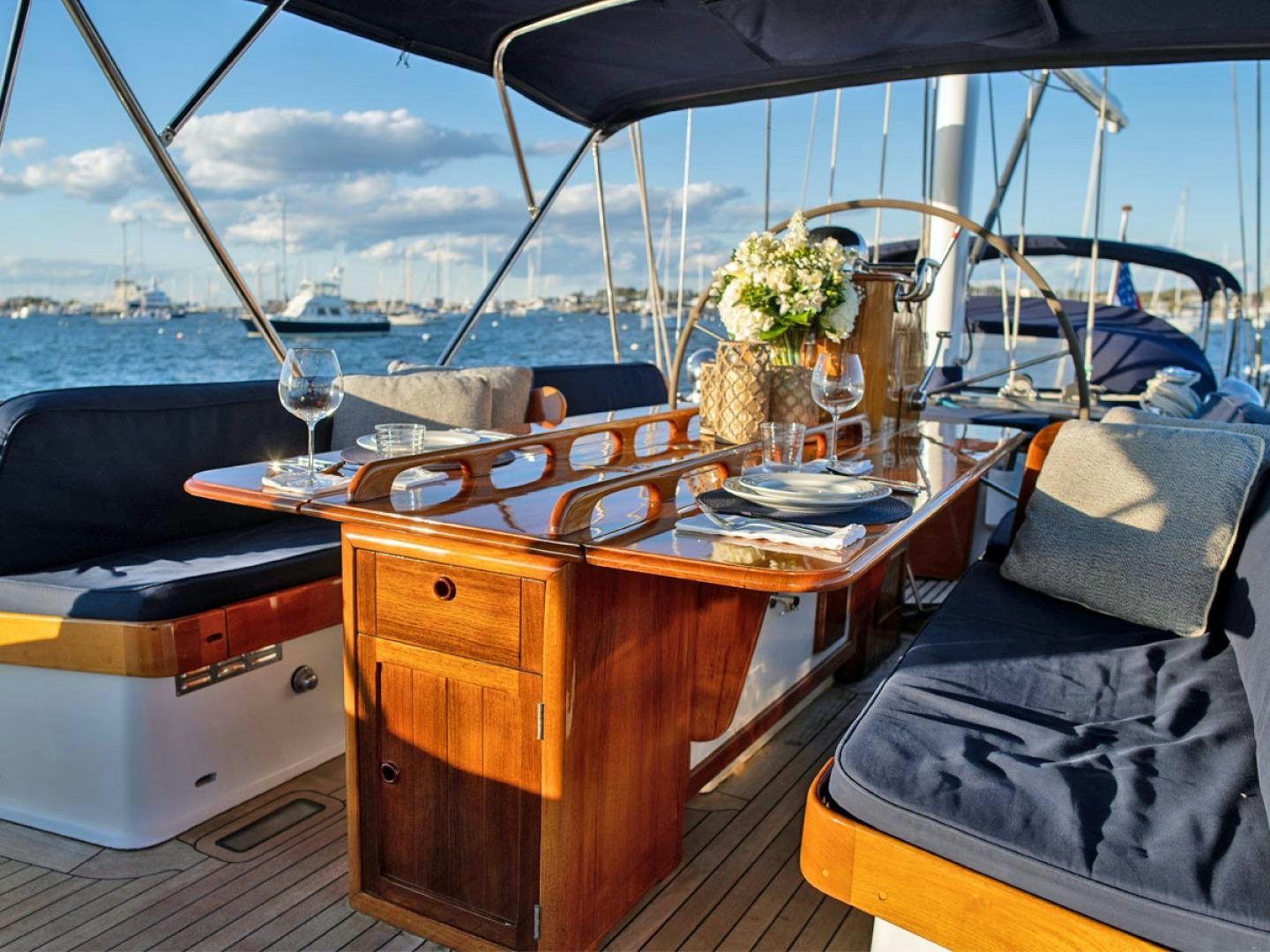 a table with a glass and a chair on it aboard HERMIE LOUISE Yacht for Sale