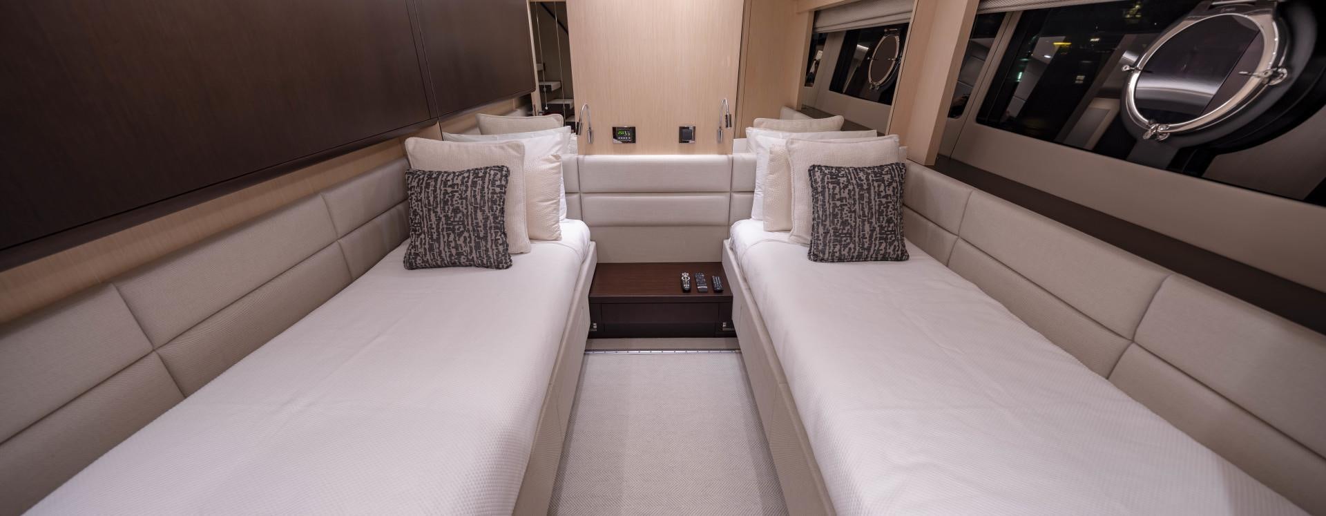 a room with a bed and a washer and dryer aboard PURA VIDA Yacht for Sale