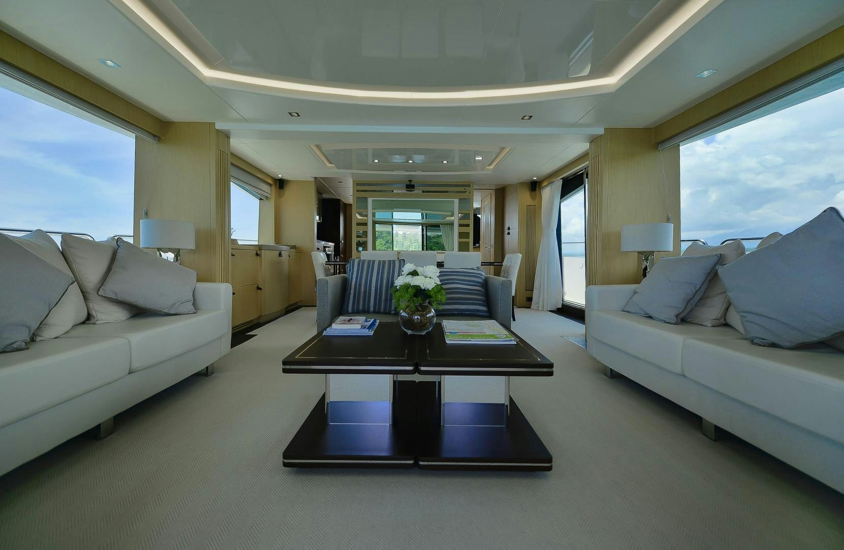 a living room with a couch and a coffee table aboard PURA VIDA Yacht for Sale