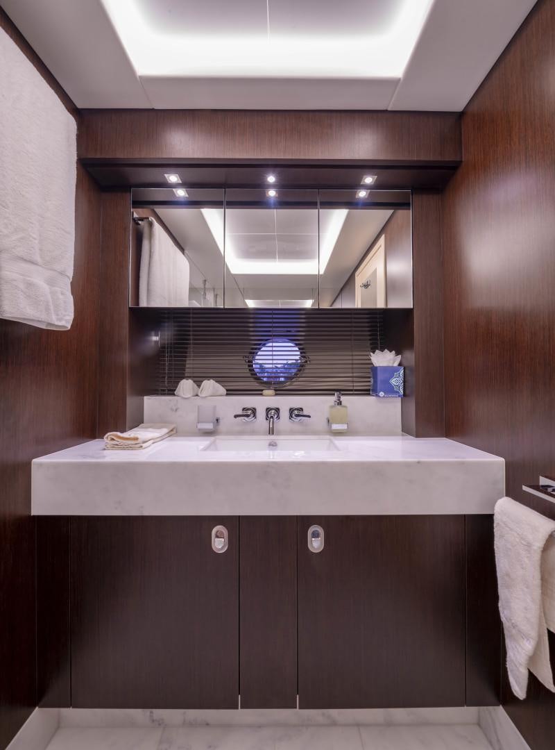 a bathroom with a sink and a mirror aboard PURA VIDA Yacht for Sale