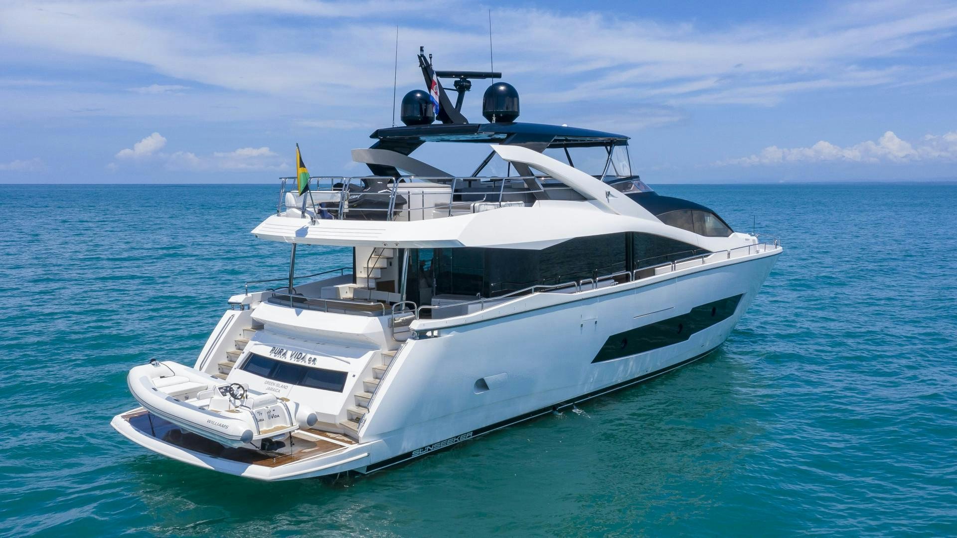 a white yacht in the water aboard PURA VIDA Yacht for Sale