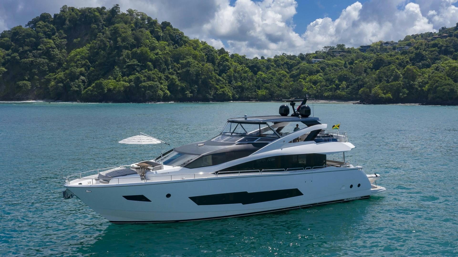 a white yacht in the water aboard PURA VIDA Yacht for Sale