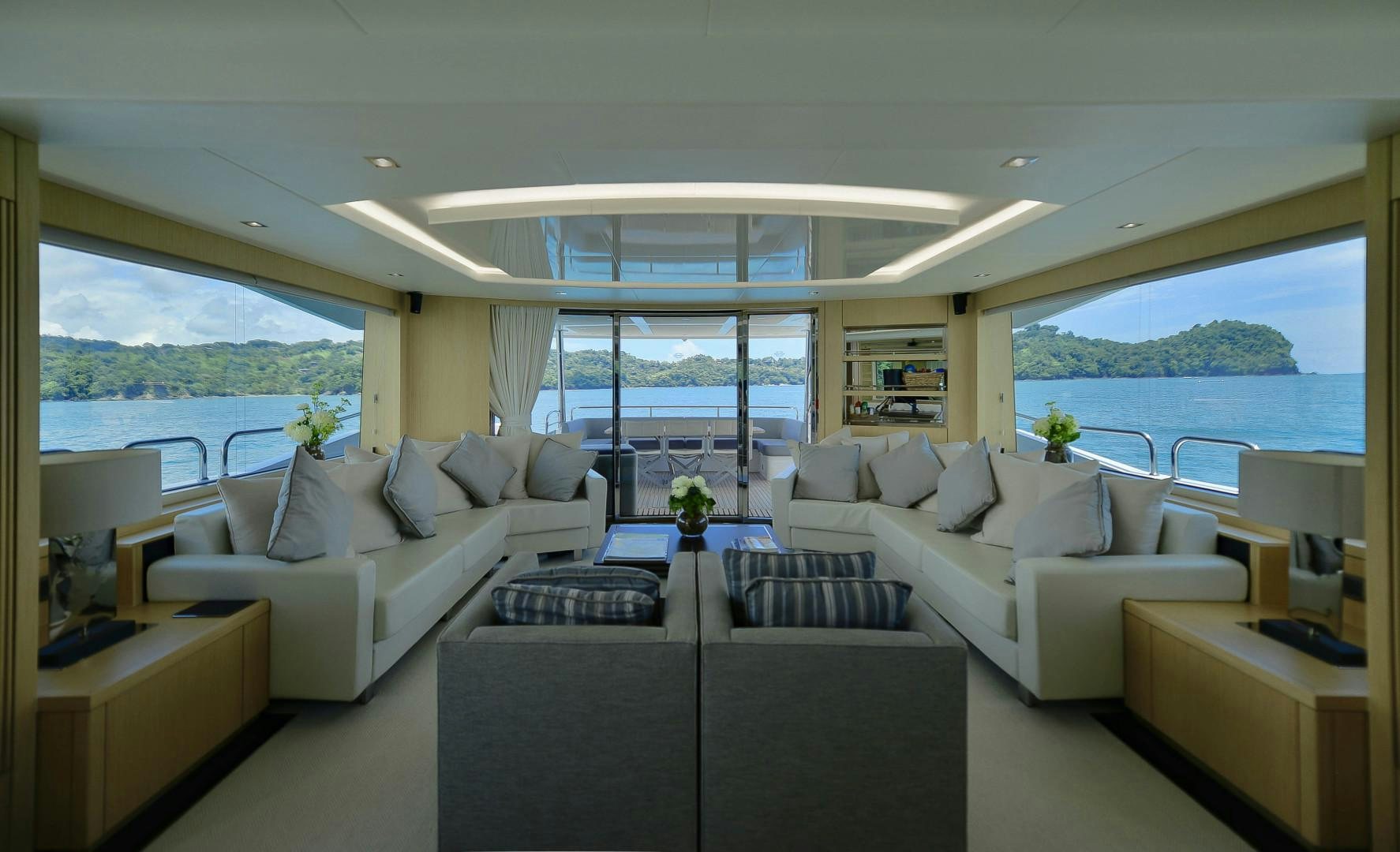 a living room with a large window aboard PURA VIDA Yacht for Sale