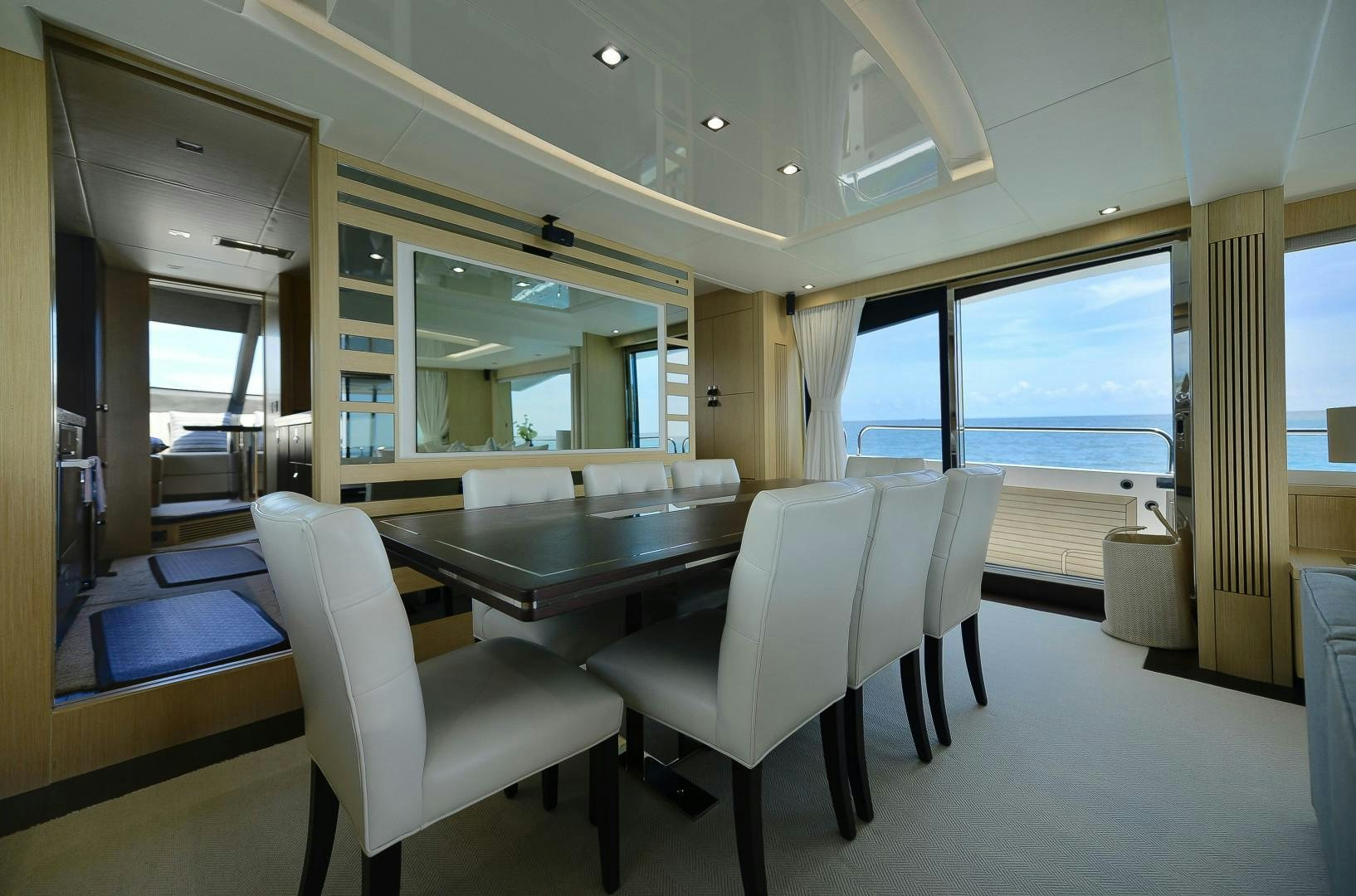 a room with a table and chairs aboard PURA VIDA Yacht for Sale