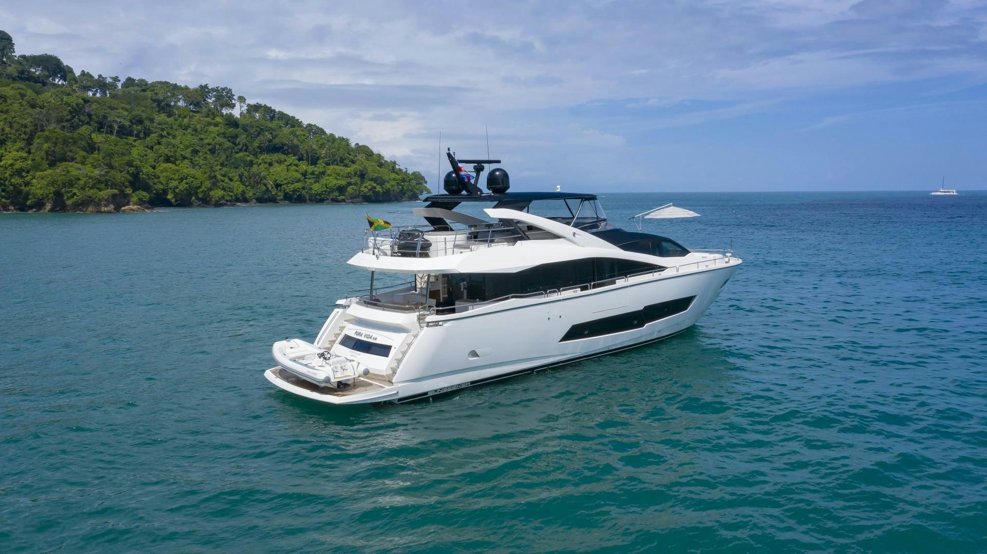 a white yacht in the water aboard PURA VIDA Yacht for Sale