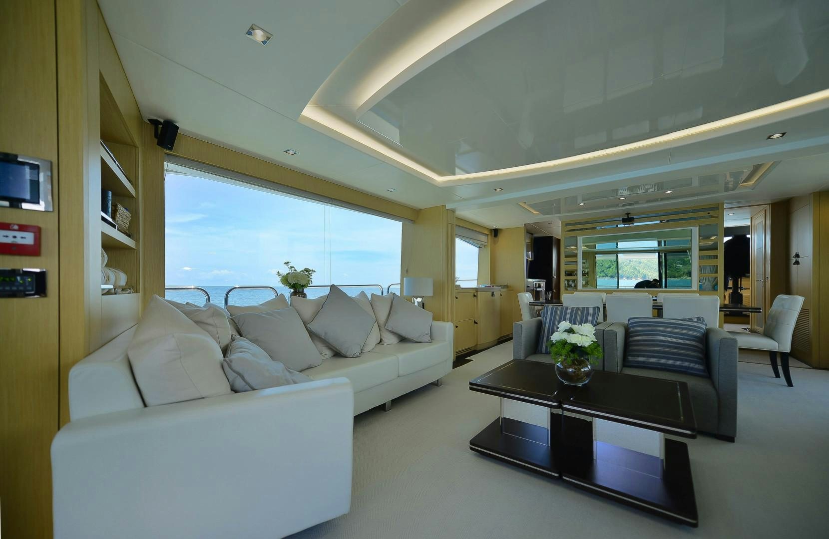 a living room with a table and couches aboard PURA VIDA Yacht for Sale