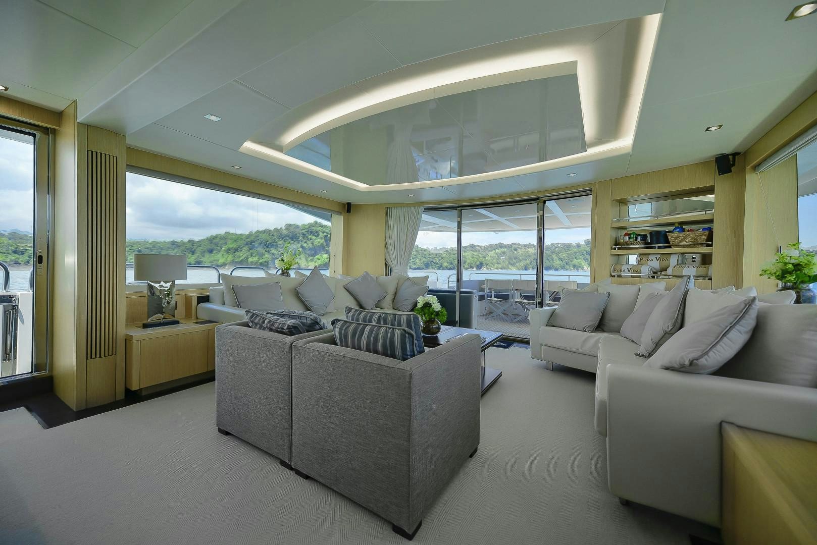 a living room with a large window aboard PURA VIDA Yacht for Sale