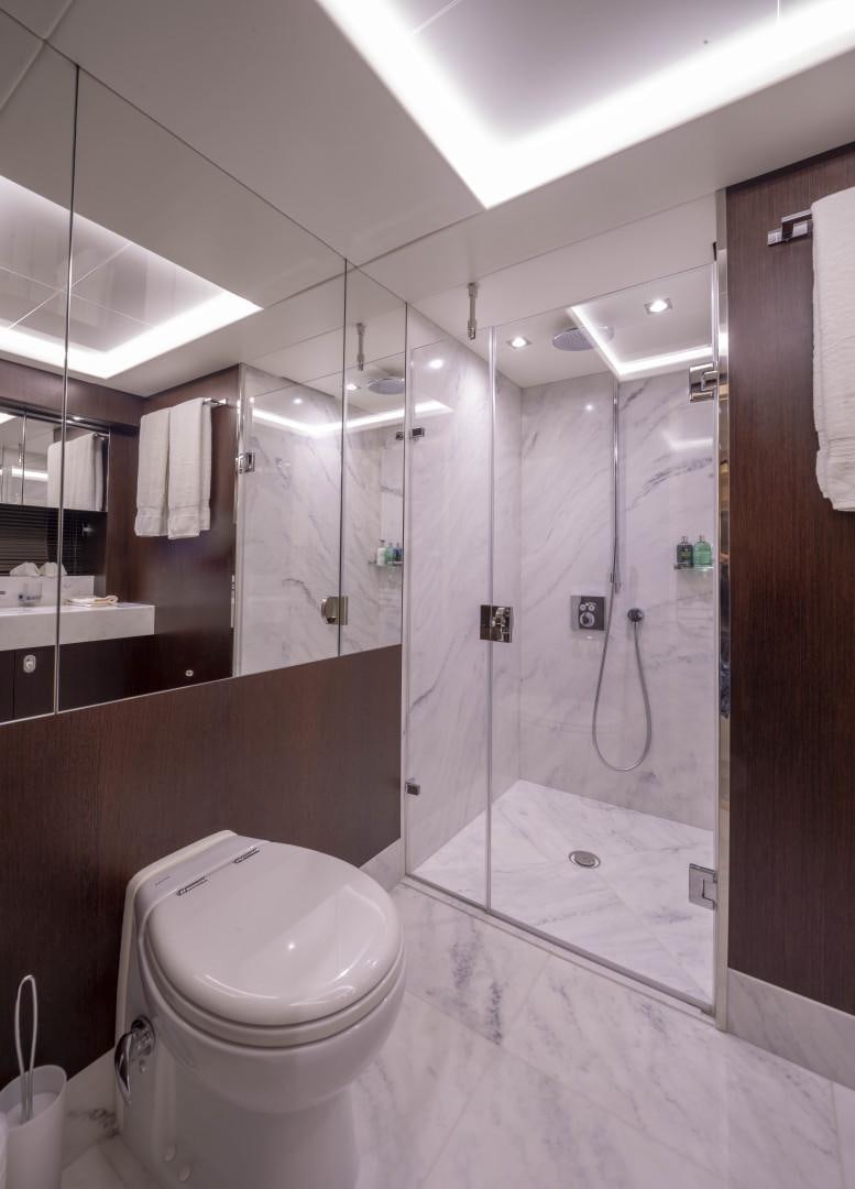 a bathroom with a glass shower aboard PURA VIDA Yacht for Sale