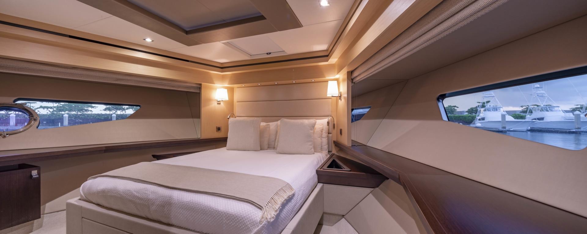 a room with a bed and a window aboard PURA VIDA Yacht for Sale