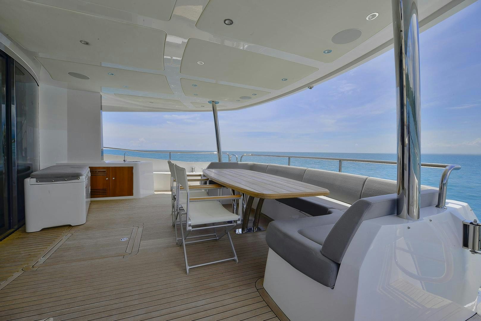 a room with a table and chairs aboard PURA VIDA Yacht for Sale