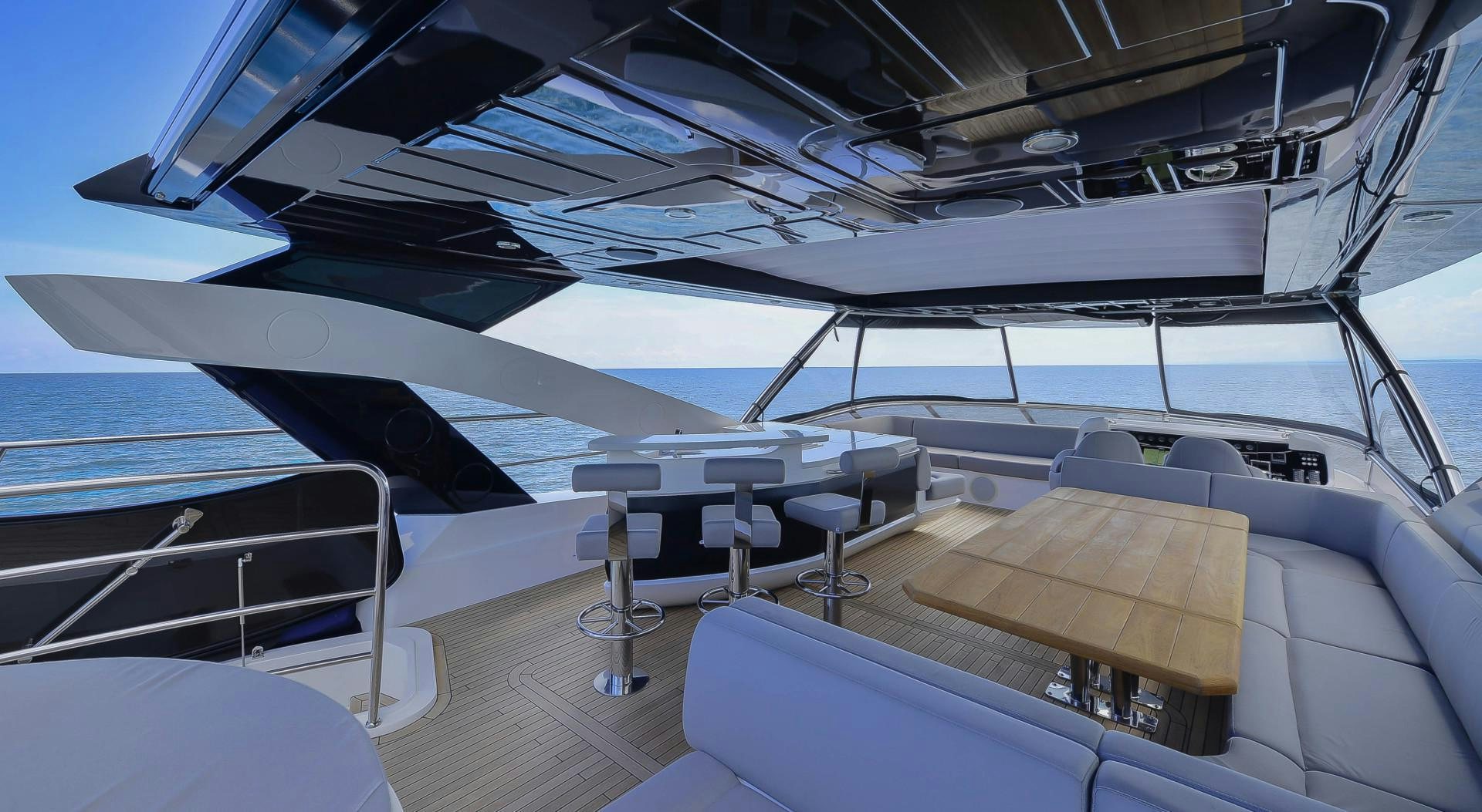 a boat with a deck and chairs aboard PURA VIDA Yacht for Sale