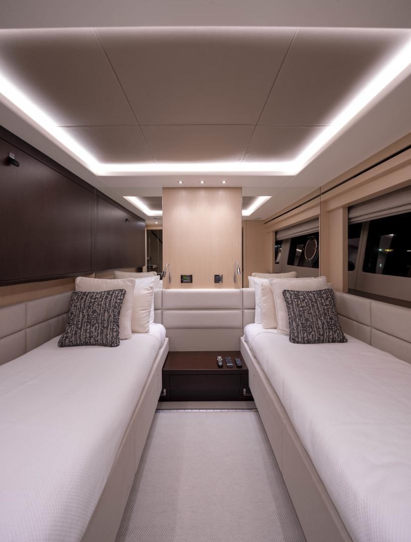 a room with white beds aboard PURA VIDA Yacht for Sale