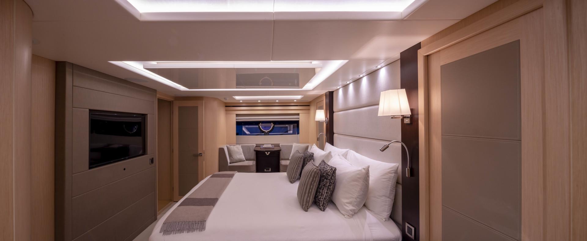 a room with a bed and a television aboard PURA VIDA Yacht for Sale