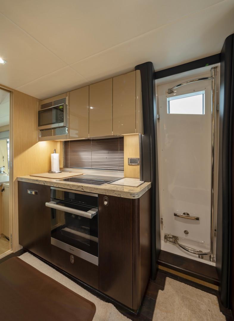 a kitchen with a refrigerator and cabinets aboard PURA VIDA Yacht for Sale