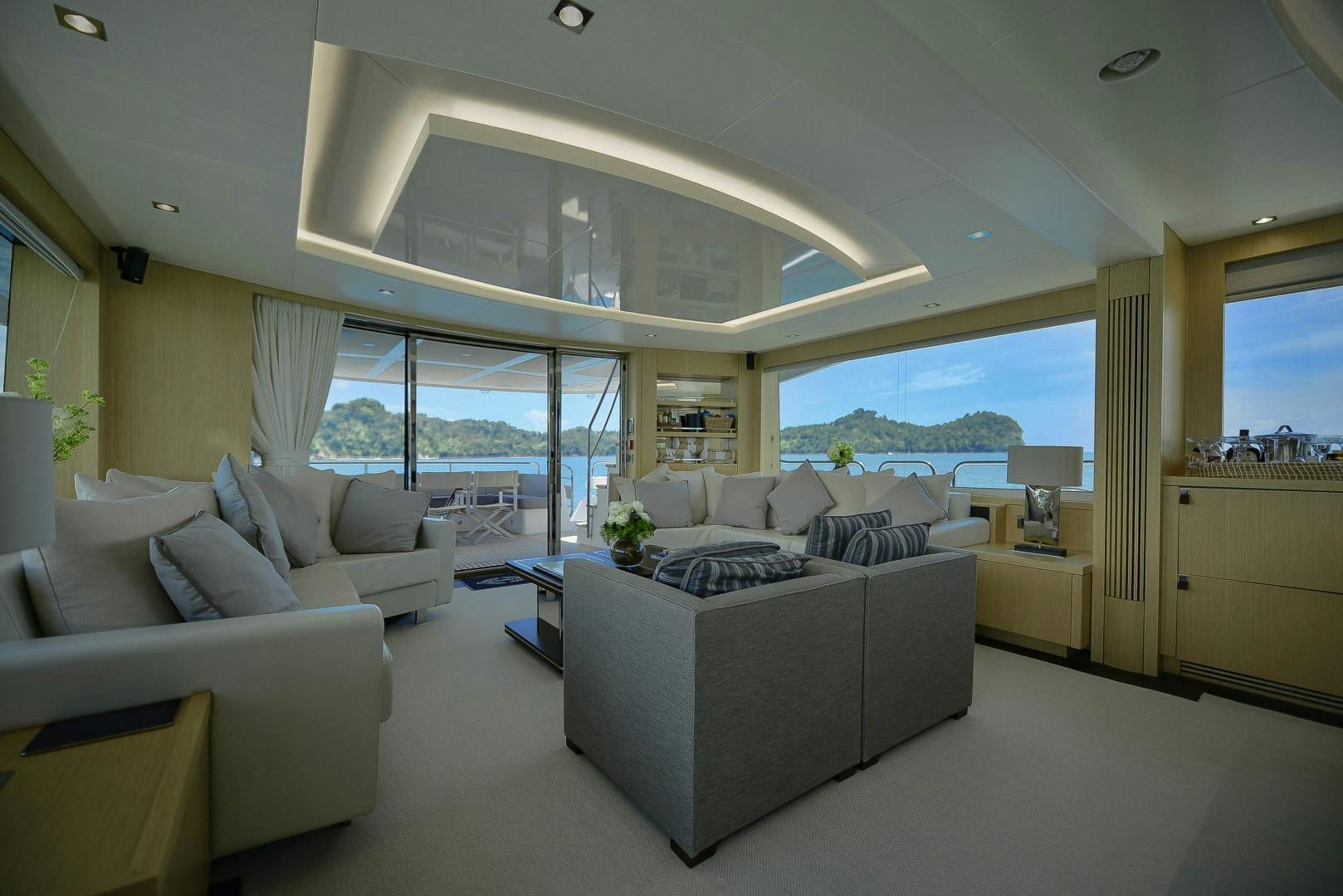 a living room with a large window aboard PURA VIDA Yacht for Sale