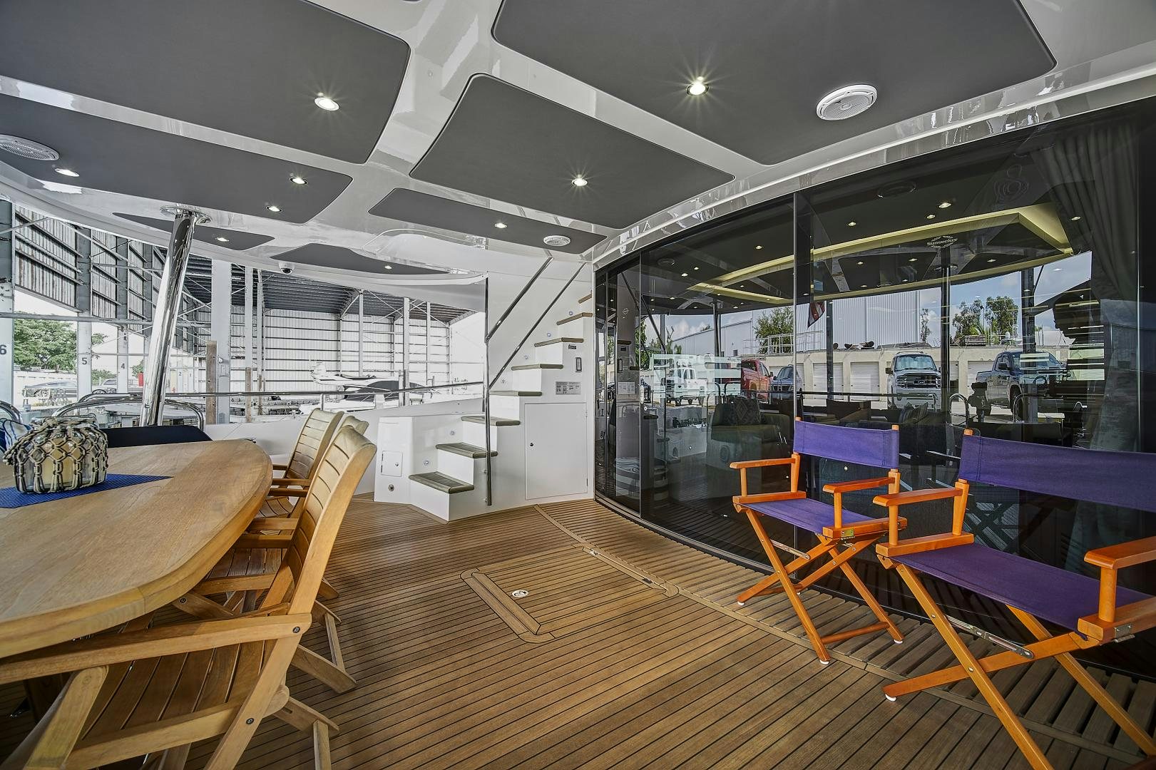 a room with tables and chairs aboard 'S NOON SOMEWHERE Yacht for Sale