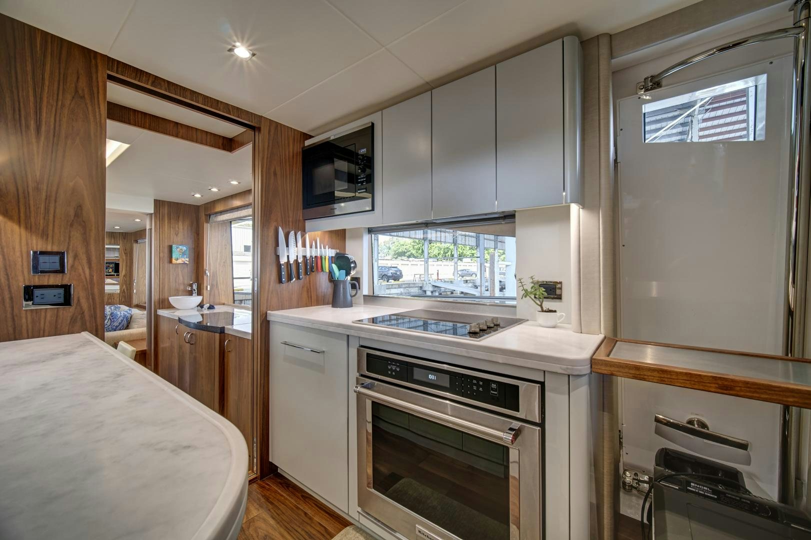 a kitchen with a refrigerator and sink aboard 'S NOON SOMEWHERE Yacht for Sale