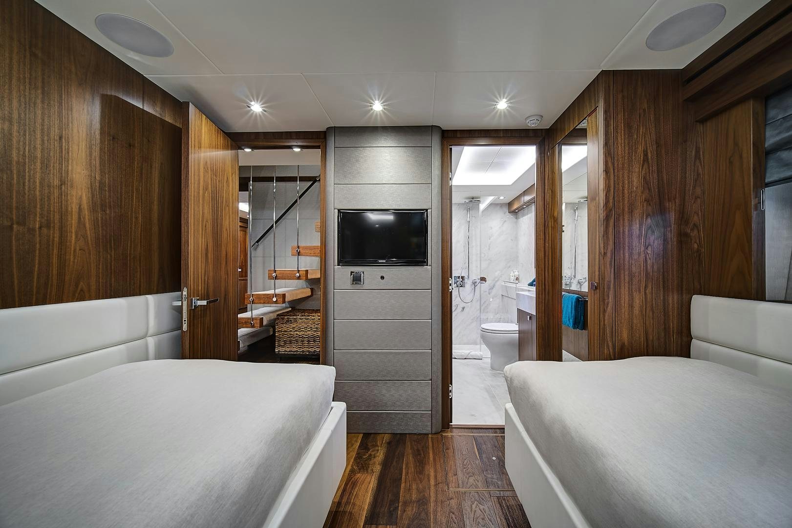 a bedroom with a bed and a television aboard 'S NOON SOMEWHERE Yacht for Sale