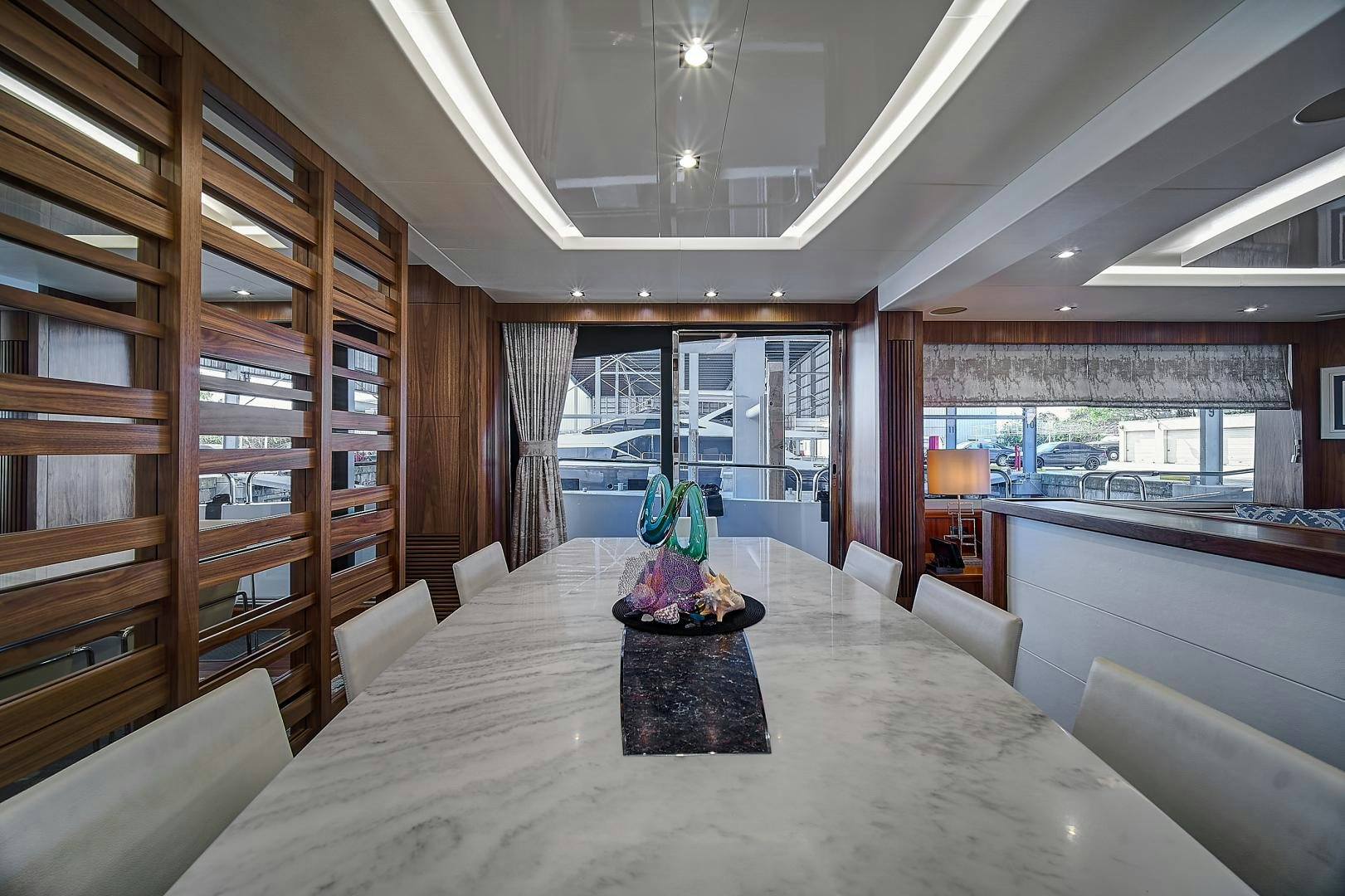 a large room with a table and chairs aboard 'S NOON SOMEWHERE Yacht for Sale